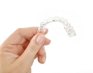 Invisalign aligner in hand